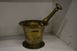 A brass pestle and mortar.