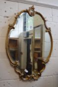A decorative gilt framed mirror.