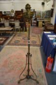 An ornate brass floor standing oil lamp.