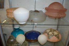A quantity of moulded glass and opaque glass lampshades.