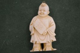 A Chinese carved figure of a boy.
