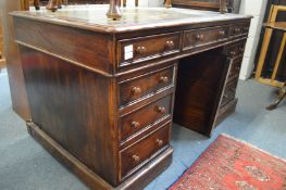 A Victorian oak pedestal desk.