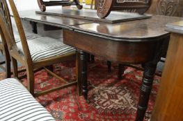 A Regency mahogany extending dining table with ratchet mechanism, two leaves on turned legs with