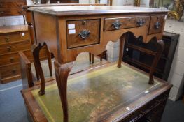 A walnut side table with leather inset top.