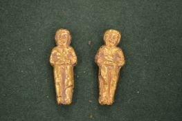 Two early gilt decorated figural amulets.