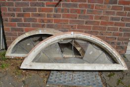 A pair of wooden and leaded light fan lights.