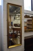 A gilt framed dressing mirror.