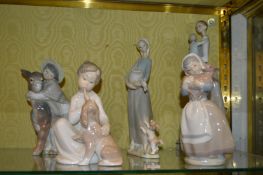 Lladro and Nao figure groups.