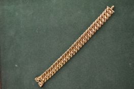 A curb link style bracelet, stamped 18ct. 42 grams