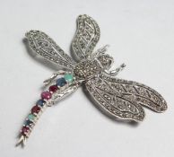 A LARGE SILVER, MARCASITE, EMERALD, SAPPHIRE AND RUBY DRAGONFLY BROOCH.