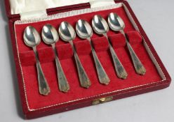 A SET OF SIX SILVER GILT SPOONS, CASED.