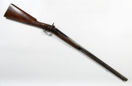 A 19TH CENTURY RIFLE with round barrell, engraved lock plate and hammer, chequered walnut stock (