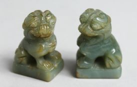 A SMALL PAIR OF CHINESE CARVED JADE FO DOGS, 1.75ins high.