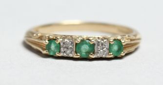 A 9CT GOLD, EMERALD AND DIAMOND RING.