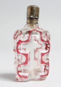 A CUT GLASS, RUBY TINTED SCENT BOTTLE WITH SILVER TOP, 3.5ins high.