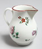 AN 18TH CENTURY BRISTOL JUG painted with a large floral spray and scattered flowers.