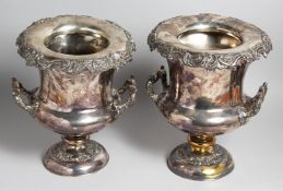 A PAIR OF SILVER PLATE URN SHAPED TWO HANDLED WINE COOLERS, 11ins high, presented in 1844.(one A/