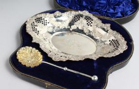 A VICTORIAN PIERCED AND EMBOSSED STRAWBERRY DISH AND SPOON in a fitted case, Sheffield 1899, with
