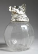 A LARGE CLEAR GLASS CLARET JUG with plated boars head lid, 11ins .