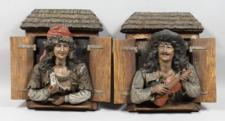 A LARGE PAIR OF CONTINENTAL POTTERY PLAQUES OF A MUSICIAN AND A YOUNG LADY at an open window