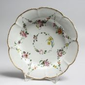 AN 18TH CENTURY BRISTOL PLATE painted with festoons of flowers under a dentil gilt border, X mark.