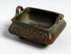 A SMALL BRONZE TWIN HANDLED CENSOR with Arabic script to the sides. 3ins wide.