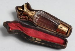 A CUT GLASS GOLD MOUNT EWER SHAPED SCENT BOTTLE IN ORIGINAL LEATHER CASE.