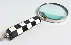 A MAGNIFYING GLASS with CHEQUERED handle.