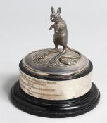 A SILVER MODEL OF A DESERT RAT by GARRARD & CO. 1994, on a circular base.