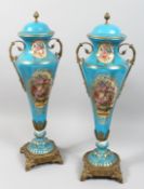 A PAIR OF SEVRES STYLE PORCELAIN AND ORMOLU TWIN HANDLED VASES AND COVERS decorated with flowers,
