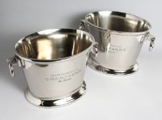 A PAIR OF OVAL PLATED WINE COOLERS with ring handles, 15ins wide.