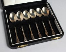 A SET OF SIX SILVER GILT SPOONS, CASED.