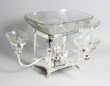 AN IMPRESSIVE SILVER PLATED AND CUT GLASS CENTRE PIECE, with central rectangular glass dish and four