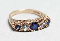 A 9CT GOLD BLUE AND WHITE STONE RING
