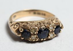 A VICTORIAN 9CT GOLD SAPPHIRE THREE STONE RING