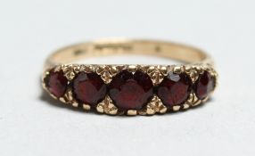 A 9CT GOLD VICTORIAN GARNET RING.