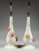 A PAIR OF MURANO OPAQUE GLASS TABLE LAMPS with pink glass floral applied decoration. 15.5ins high.