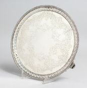 A GOOD VICTORIAN ENGRAVED CIRCULAR SALVER with pierced border, 8.75in diameter, London 1867, maker
