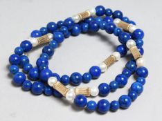 A GOLD, PEARL AND LAPIS NECKLACE, 24ins long.