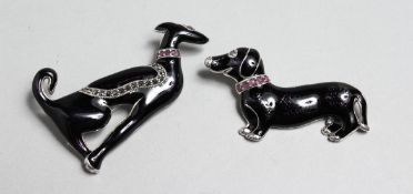 TWO SILVER AND ENAMEL DACHSHUND DOG BROOCHES.