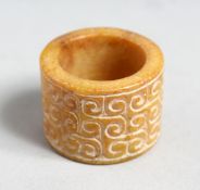 A CHINESE CARVED JADE ARCHERS RING