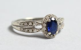 A 9CT WHIE GOLD SAPPHIRE AND DIAMOND CLUSTER RING.