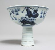 A CHINESE BLUE AND WHITE STEM CUP, the interior with moulded dragon decoration. 4.75ins diameter.
