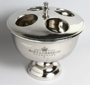 A FOUR BOTTLE WINE COOLER on a circular base, 15ins high.