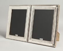 A LARGE PAIR OF SILVER PHOTOGRAPH FRAMES 22cm x 17cm.
