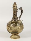 A CONTINENTAL WINE JUG, with green tinted glass body, decorative gilt metal mounts and stopper. 12.