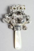 A SILVER AND MOTHER OF PEARL TEDDY RATTLE.