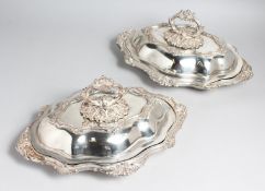 A PAIR OF VICTORIAN PLATED SHAPED ENTRÉE DISHES with rococo decoration.