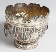 A VICTORIAN SILVER MONTEITH BOWL, semi fluted, with lion ring handles, London, 1896, makers, The
