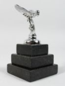 A SMALL CHROME PLATED ROLLS ROYCE CAR MASCOT on a stepped marble base. 4.75ins high.